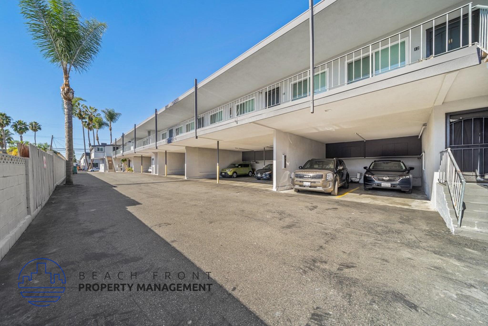 a large white building with cars parked in a parking lot